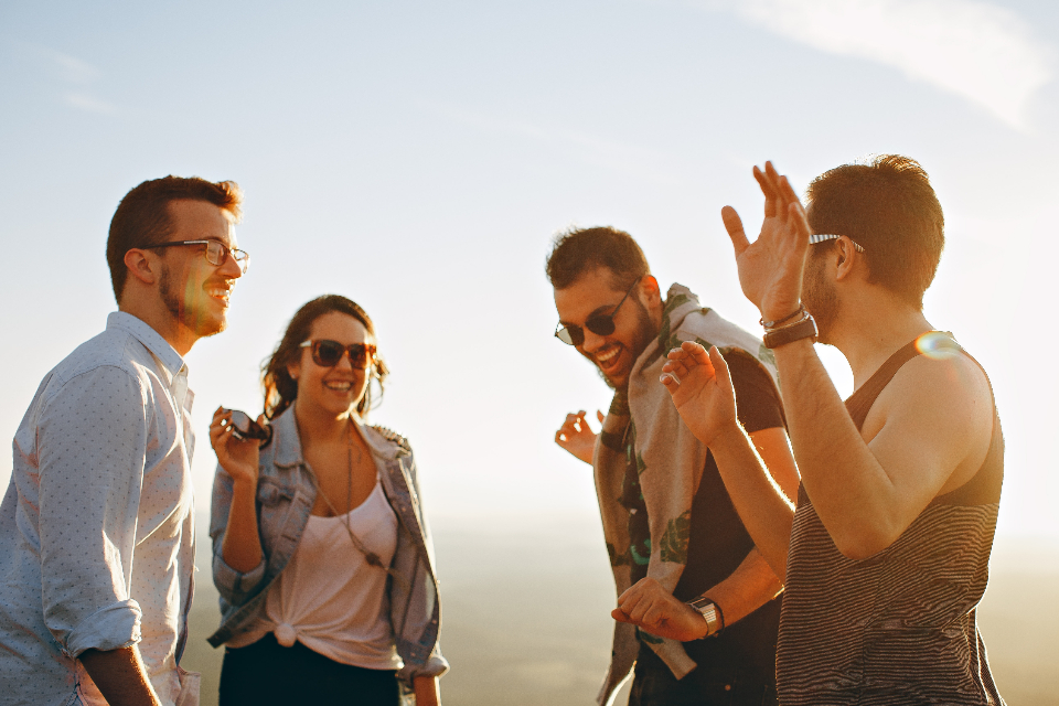 Group of friends laughing and talking outdoors